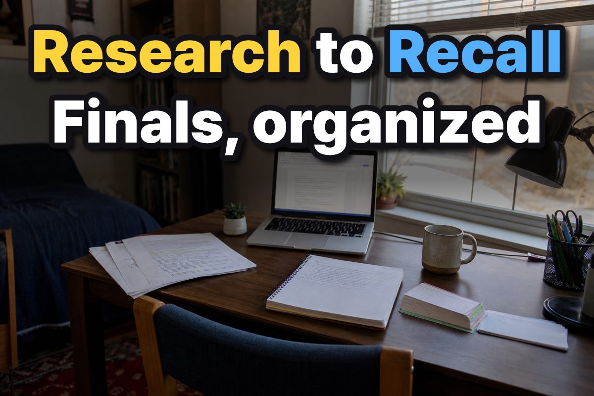 A college study desk with research papers, a laptop, notes, and flashcards.