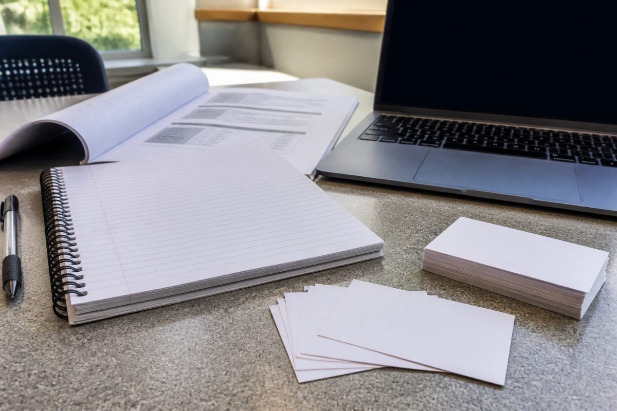 Blank flashcards and course notes set out for a college study session.