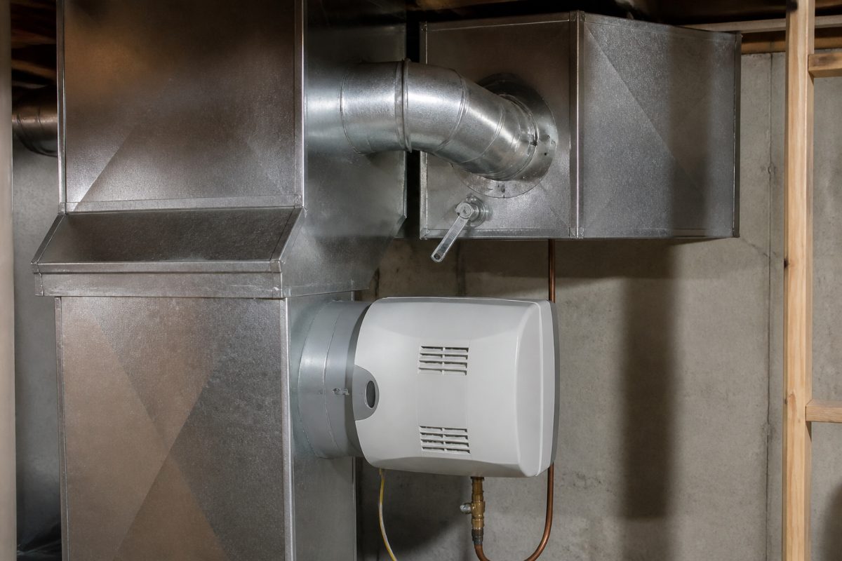 A bypass humidifier connected to rectangular ductwork with its seasonal damper visible.