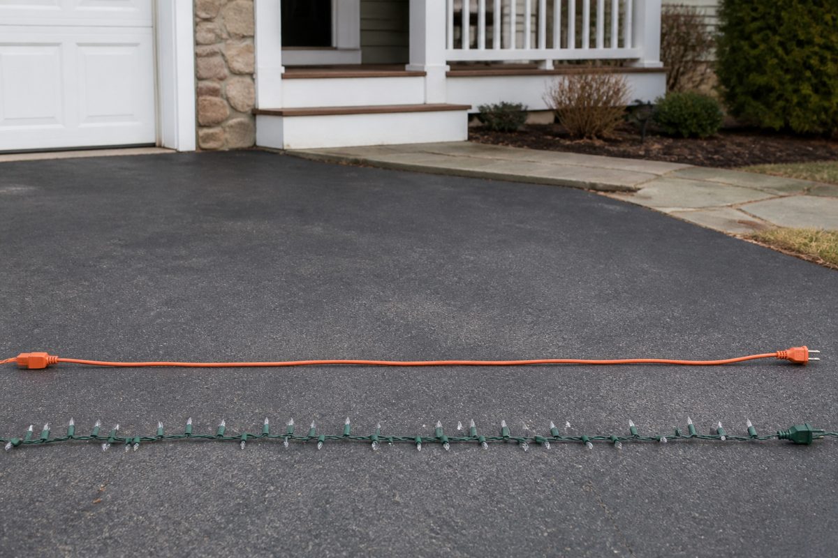 A cord and light string are spread out for a visual inspection before installation.