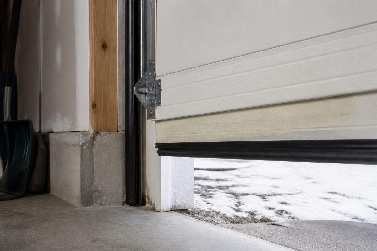 An insulated garage door with weather seals closing gaps around its edges.