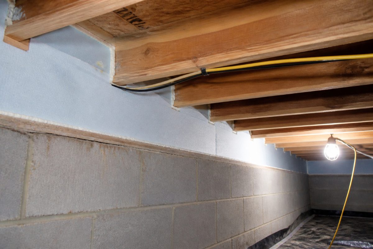 Fitted rigid foam pieces with sealed edges insulating crawl space rim-joist bays.