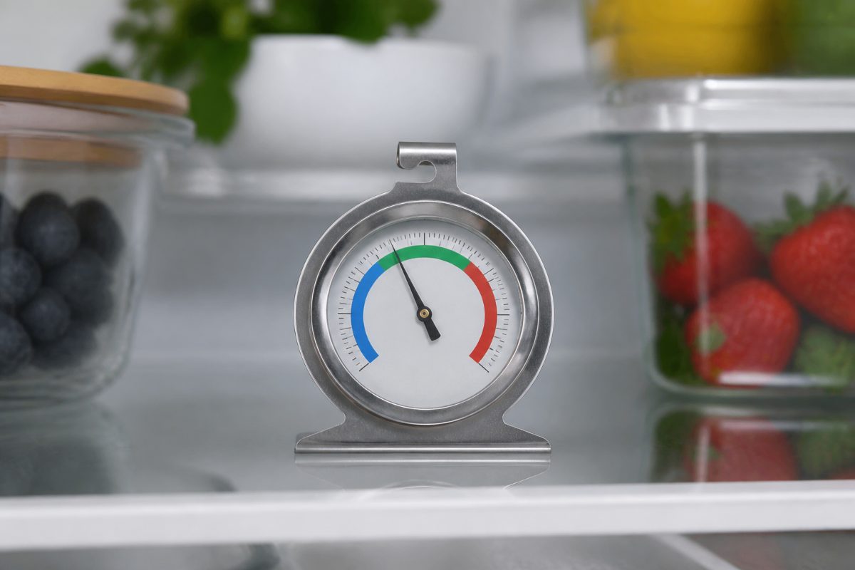 A refrigerator thermometer displaying a safe temperature below 40 degrees Fahrenheit.