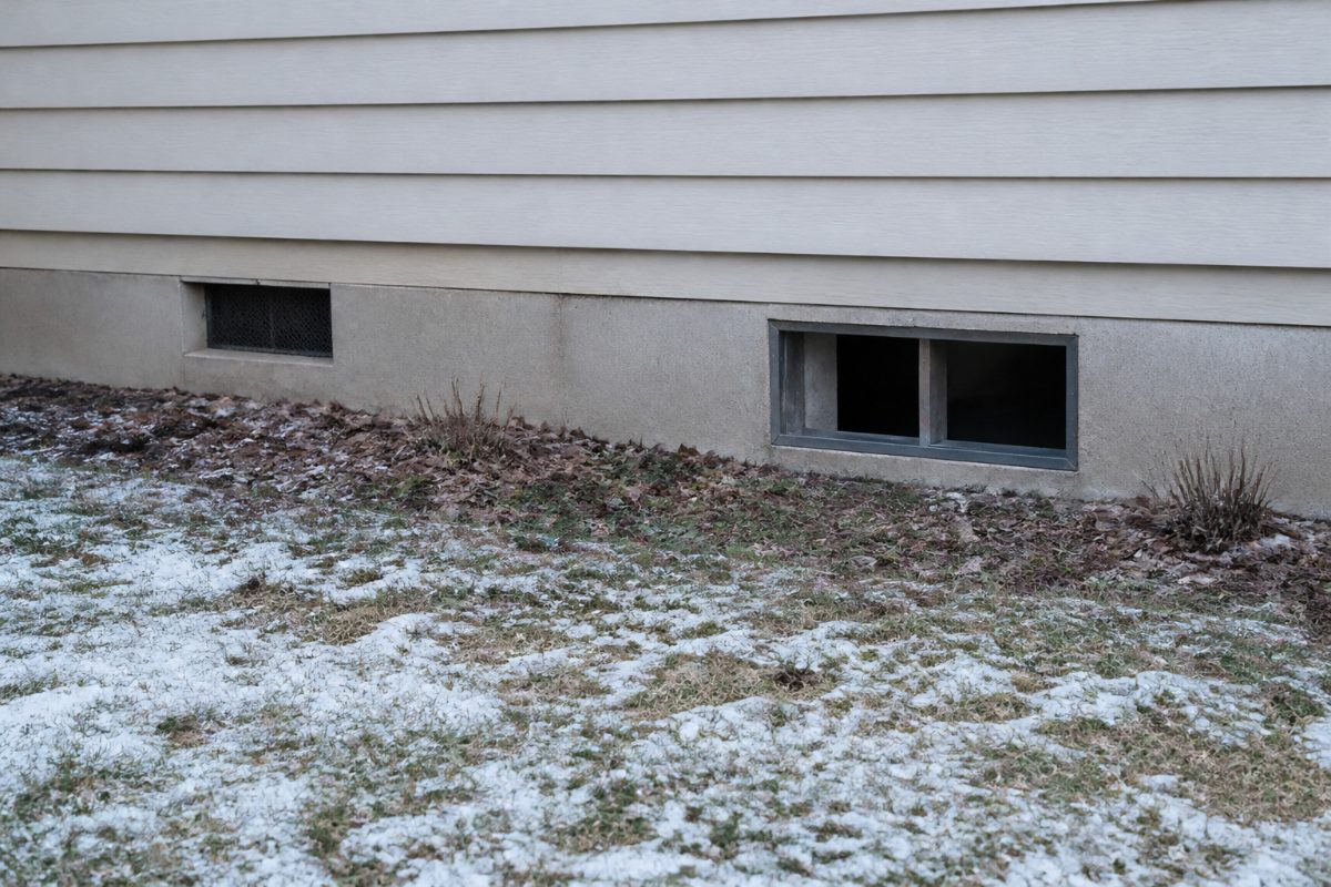 Two different foundation openings on a home illustrate why each vent should be identified before covering it.